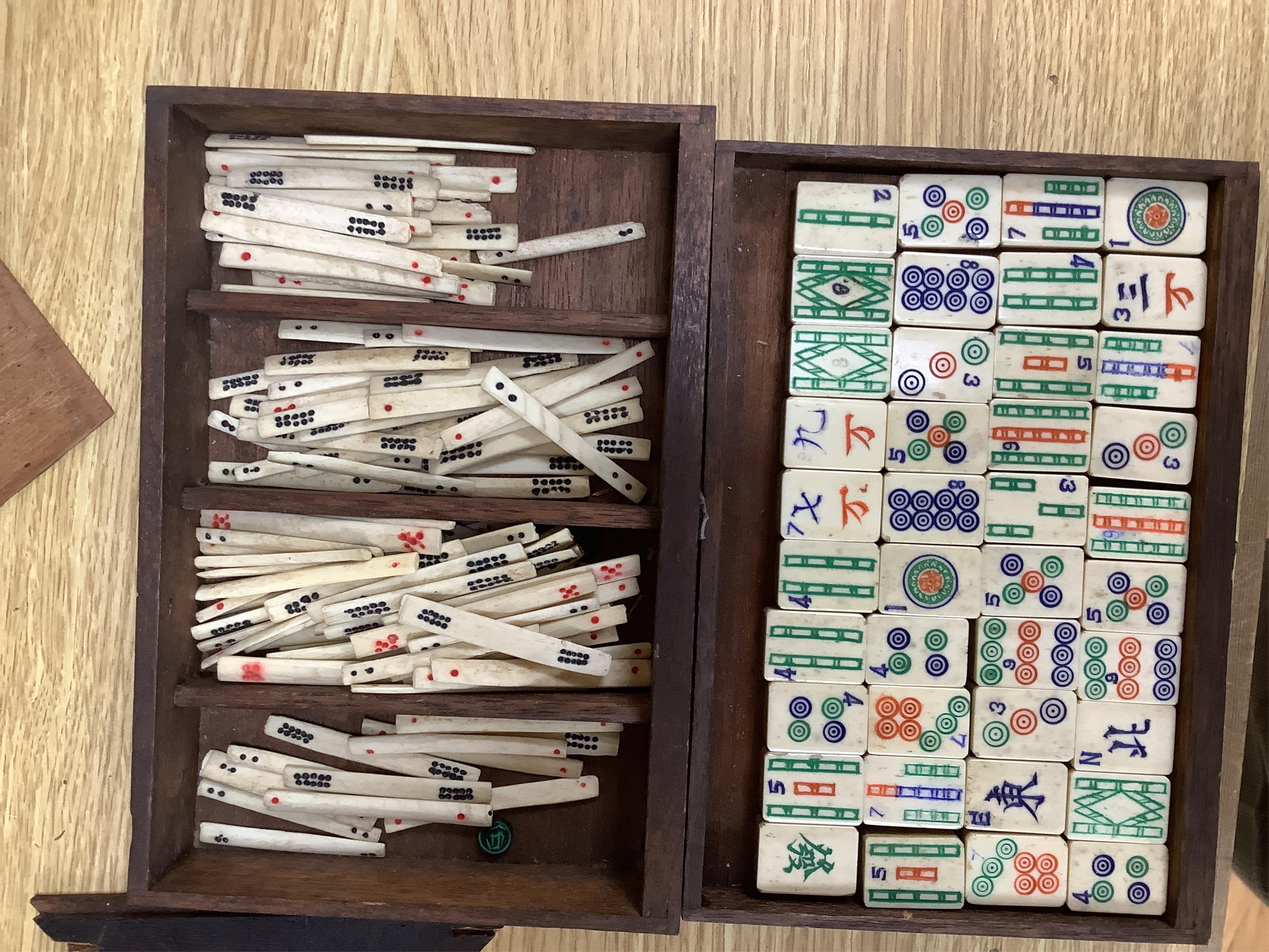 A cased Chinese Mahjong set, bone pieces